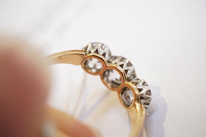 An attractive three-stone diamond ring, early 20th century